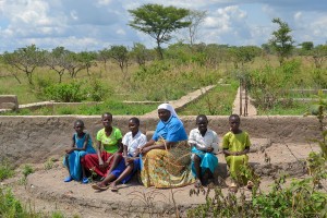 Sister Janepha, with girls from the village, pose together on the dormitory's foundation - their future school!